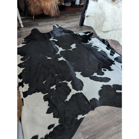 Black and white cowhide rug with natural fur texture and incredibly soft underfoot for beautiful rugs in living space