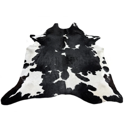 Large black and white cowhide rug with soft underfoot fur texture