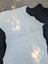 Large black and white belted galloway cowhide rug with natural fur texture adds rustic charm to any space