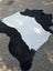Large black and white belted galloway cowhide rug with natural fur texture adding rustic charm