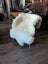 Cream-colored british isles sheepskin rug draped over wooden chair in brit12 48 x 32 british isles sheepskin