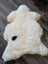 Cream-colored british isles sheepskin rug with a dark brown spot 48 x 32 inches soft and cozy isles sheepskin