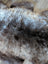 A plush british isles sheepskin faux fur rug in natural brown and gray tones with soft dense texture 47 by 31 inches