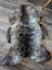 A plush british isles sheepskin rug with soft gray and brown fur texture measuring 47 by 31 inches