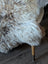 Fluffy naturally textured british isles sheepskin rug in cream and light brown tones for cozy home decor