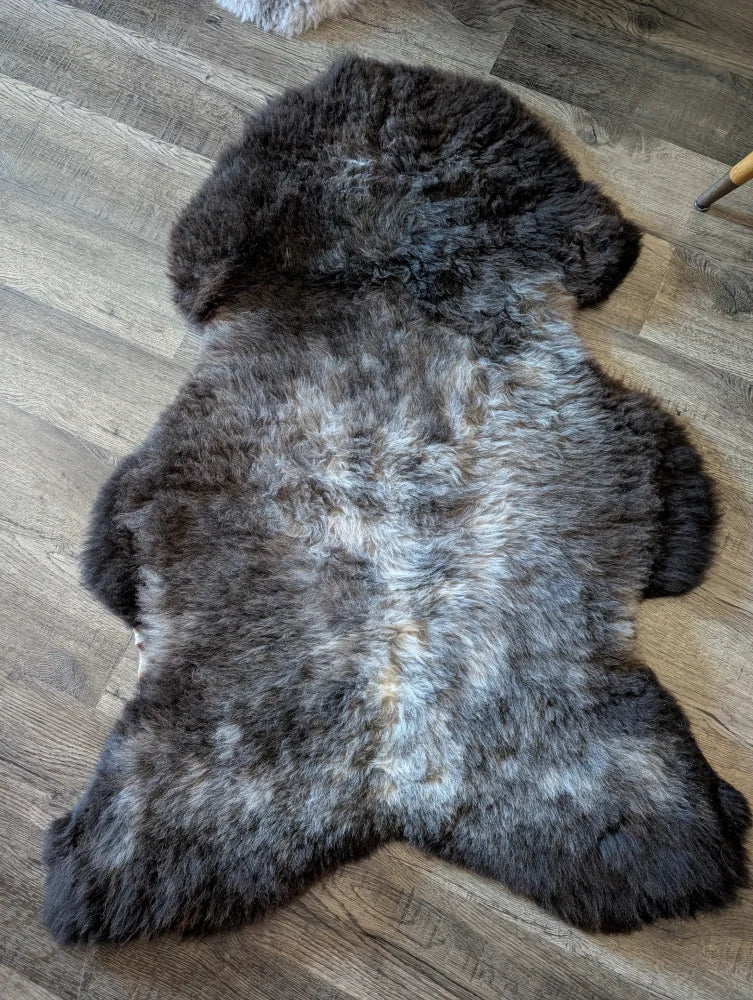 A plush british isles sheepskin rug with natural texture and a gray gradient perfect for cozy home decor