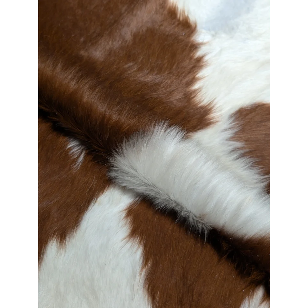 Fluffy brown and white faux fur scarf on extra large cowhide rug