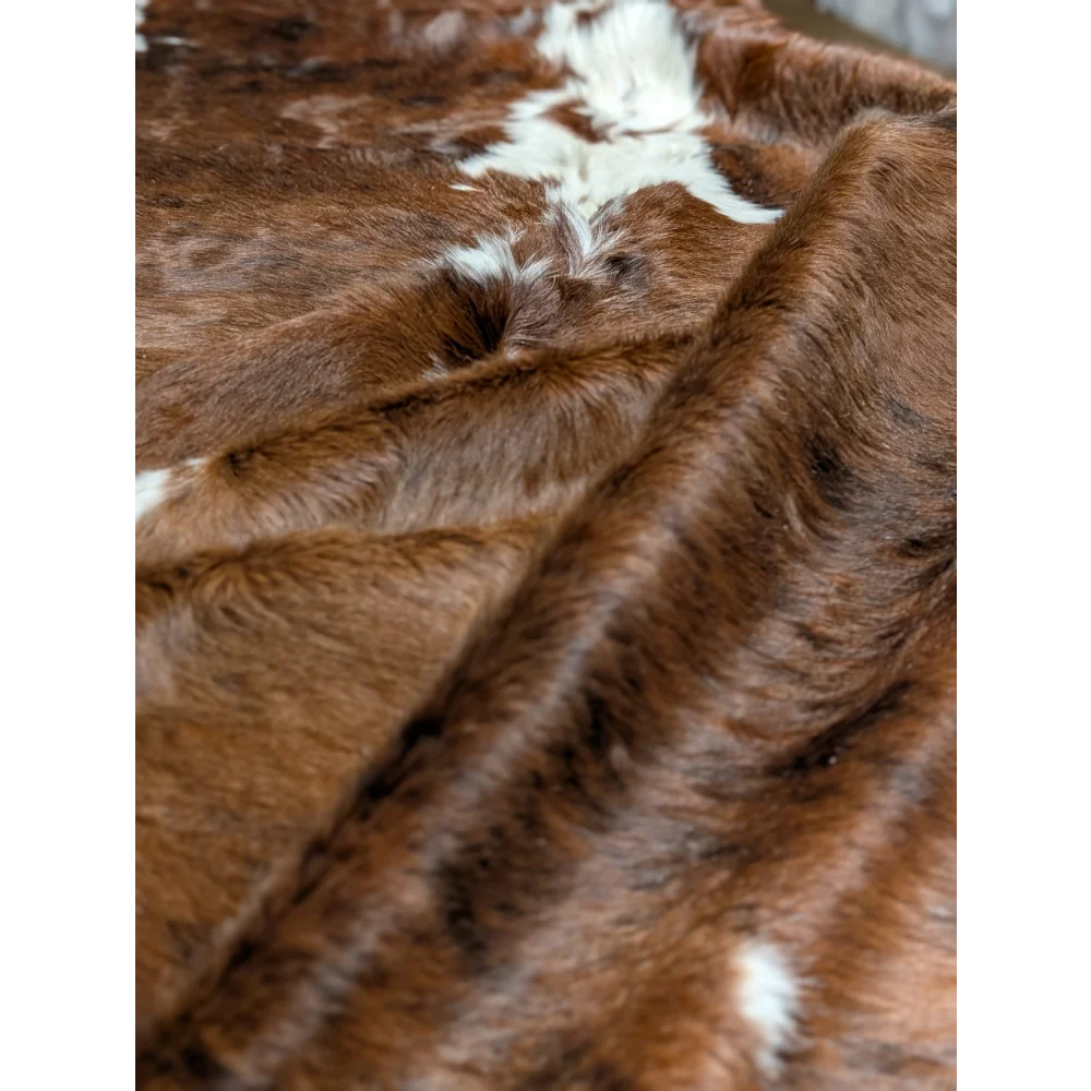 Gorgeous extra large cowhide rug in brown and white faux fur, soft underfoot with plush texture and unmistakable aura