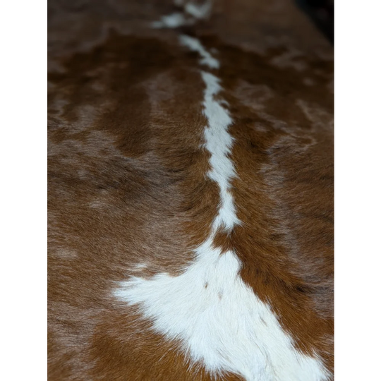 Gorgeous extra large cowhide rug in brown and white with central stripe, soft underfoot
