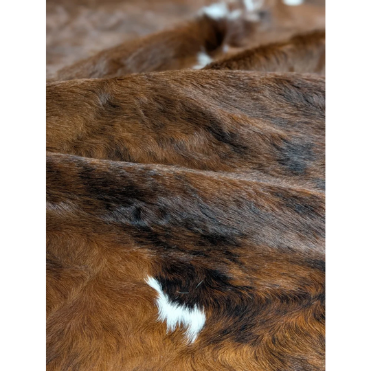Gorgeous extra large cowhide blanket in brown and white, soft underfoot with unmistakable aura
