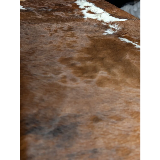 Gorgeous extra large cowhide rug in brown and white, soft underfoot with unmistakable aura