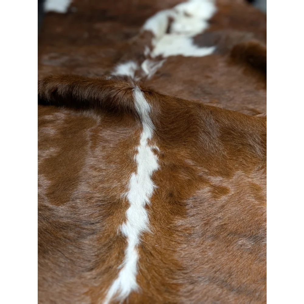 Gorgeous extra large cowhide rug in brown and white with central stripe, soft underfoot