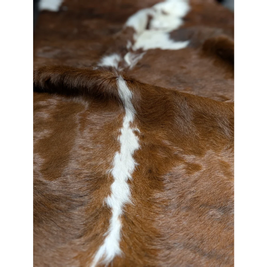 Gorgeous extra large cowhide rug in brown and white with central stripe, soft underfoot