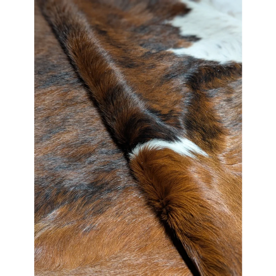 Gorgeous extra large cowhide rug in brown white fur, soft underfoot with unmistakable aura