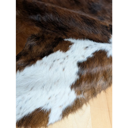 Gorgeous extra large cowhide rug in brown and white, soft underfoot with natural texture and unmistakable aura