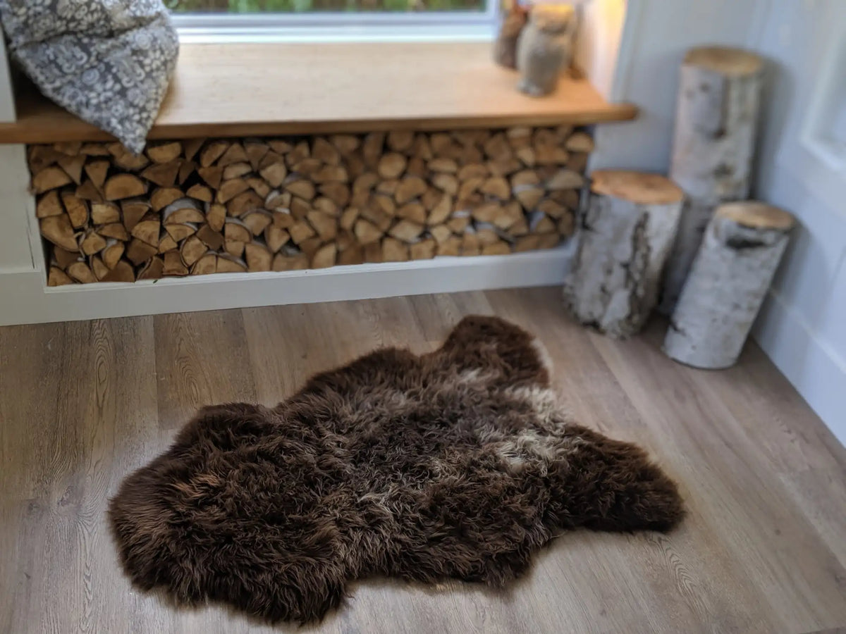 Brown sheepskin rug with natural texture and soft pile, likely from a scandinavian brand known for rustic decor.