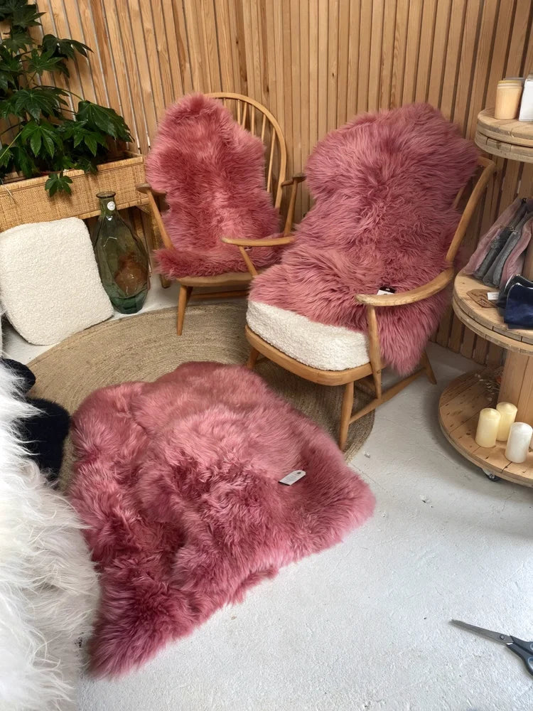 Bubblegum colour merino sheepskin rug with soft fluffy texture and natural edges in dusty pink shade arriving soon