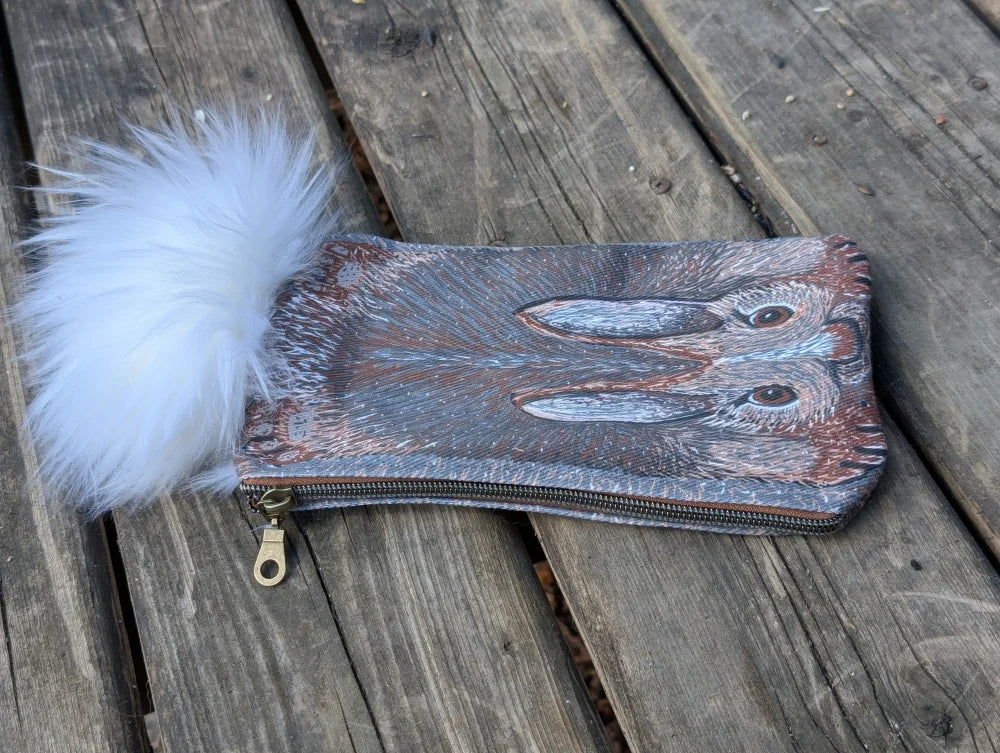 Bunny coin purse made of gray and brown cotton canvas with detailed hare design and fluffy sheepskin tail pom-pom