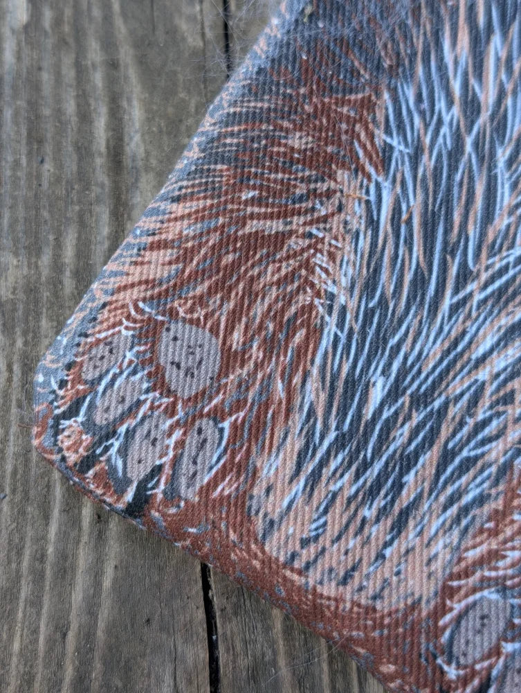 Textured cotton canvas coin purse with reddish-brown blue fur print gray paw prints and a fluffy sheepskin tail