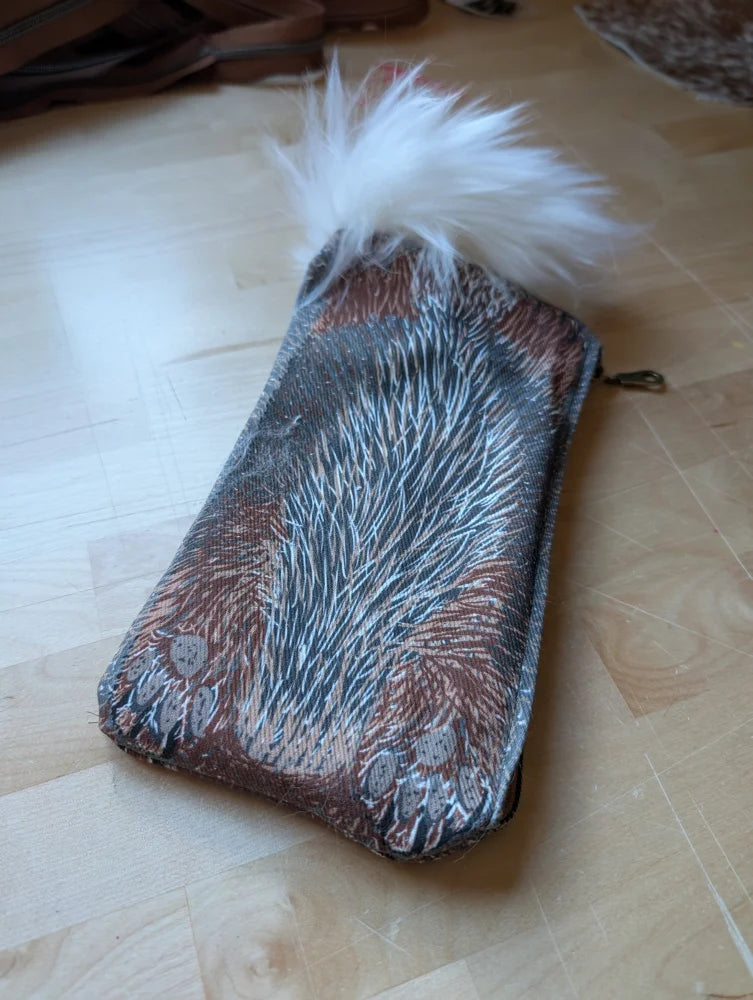 Bunny coin purse with cotton canvas fabric and brown gray feather pattern topped with fluffy white sheepskin tail