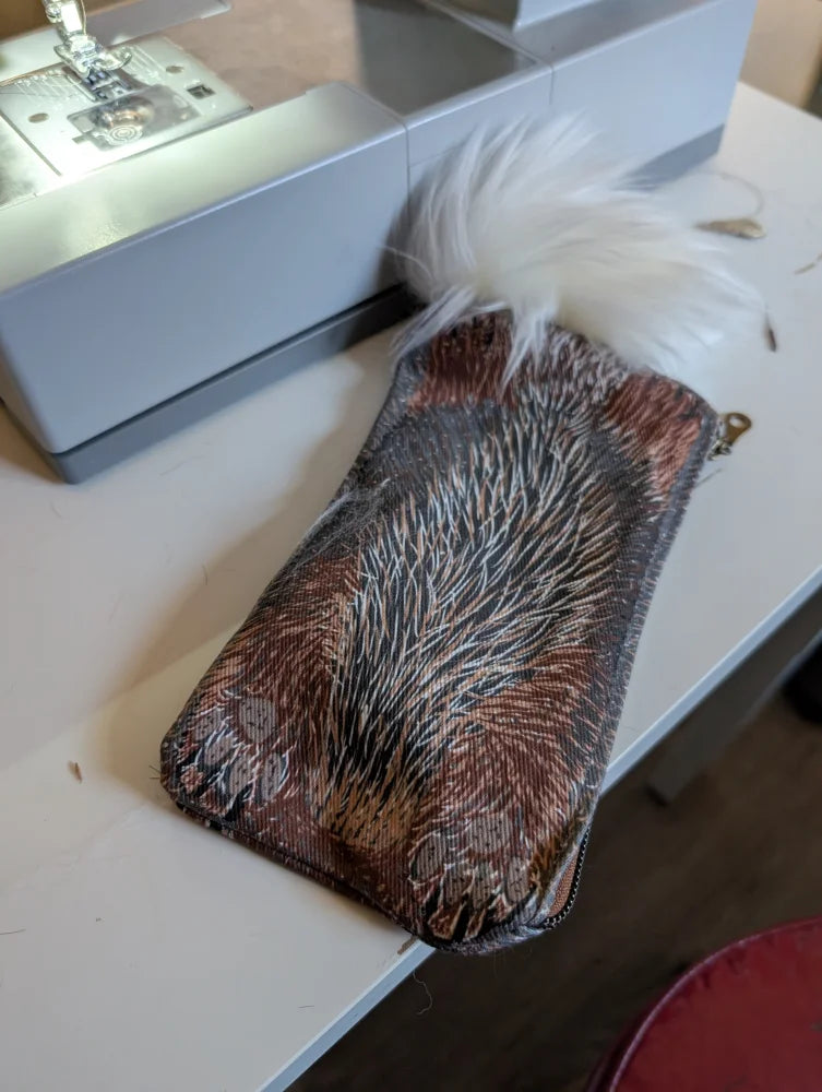Bunny coin purse in brown and black cotton canvas with a white sheepskin tail tuft on top