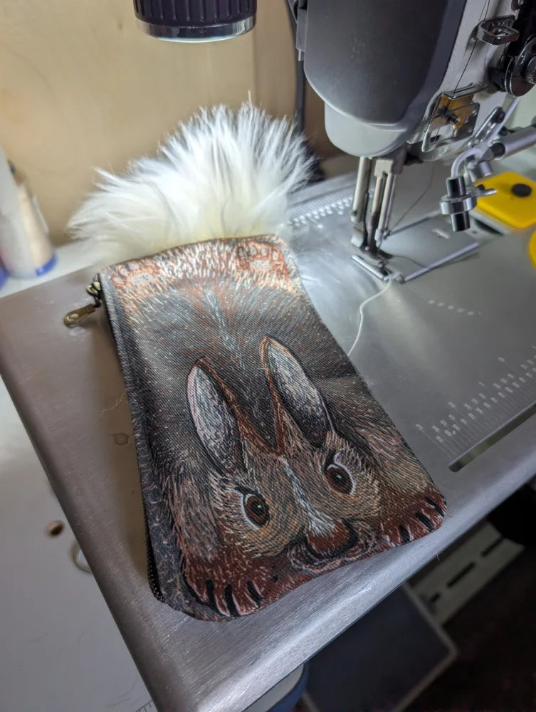 Bunny coin purse with detailed rabbit illustration on cotton canvas and fluffy sheepskin tail zipper pouch