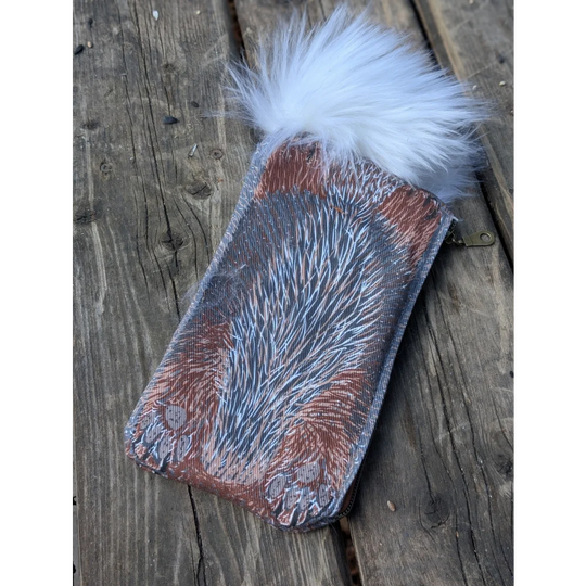 Bunny coin purse with reddish brown cotton canvas textured like fur and a fluffy white sheepskin tail pom-pom