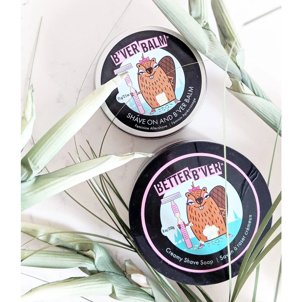 Two circular black and pink bver balm and creamy shave soap containers featuring a beaver with seed oil and coconut oil
