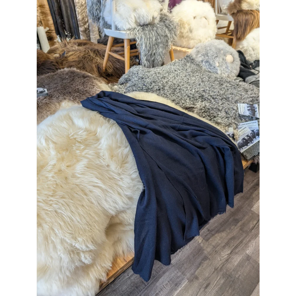 Soft navy blue cashmere scarf with plush texture and subtle sheen