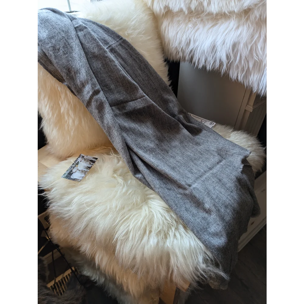Cozy gray plush throw blanket with white sheepskin fur trim