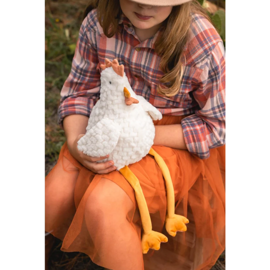 Charlie the Chicken plush toy on girl’s lap, soft sheepskin feel