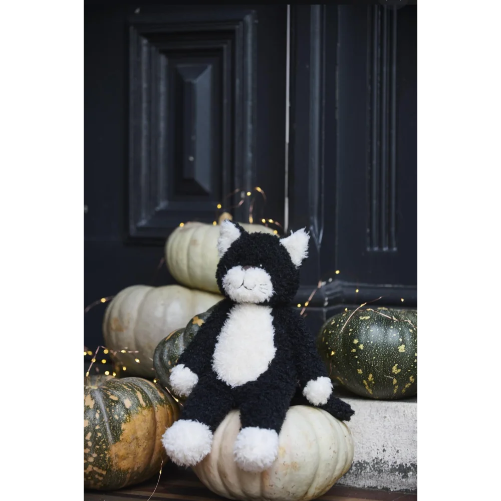 Black and white Checkers The Cat plush toy with sheepskin pom-pom paws