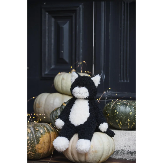 Black and white Checkers The Cat plush toy with sheepskin pom-pom paws