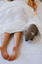 A brown knitted woolly wombat plush toy with white embroidered eyes and ears from clearance wally the wombat