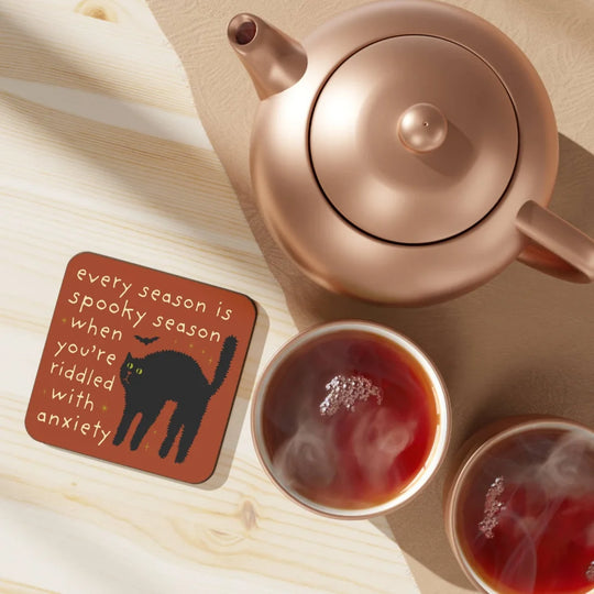 Rose gold teapot on spooky season Angus Oliver cat coaster with steaming tea