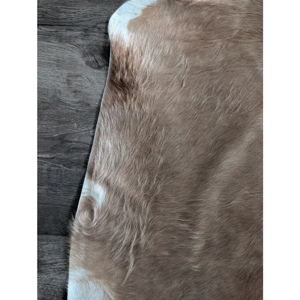 Brown and white large cowhide rug with soft natural fur texture showcasing unique characteristics and beautiful rugs style