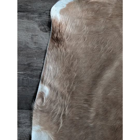 Brown and white large cowhide rug with soft natural fur texture showcasing unique characteristics and beautiful rugs style