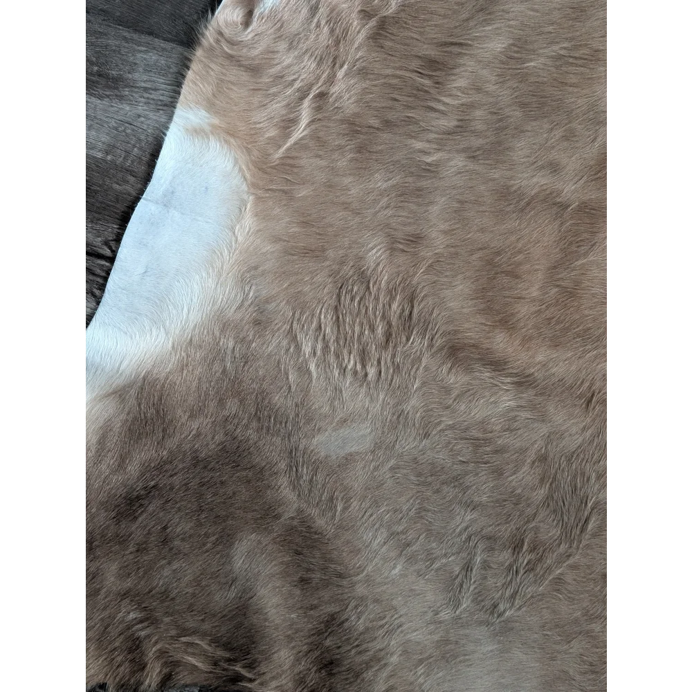 Large cowhide rug with brown and white faux fur and soft plush texture perfect for beautiful rugs lovers