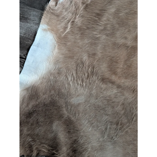 Large cowhide rug with brown and white faux fur and soft plush texture perfect for beautiful rugs lovers