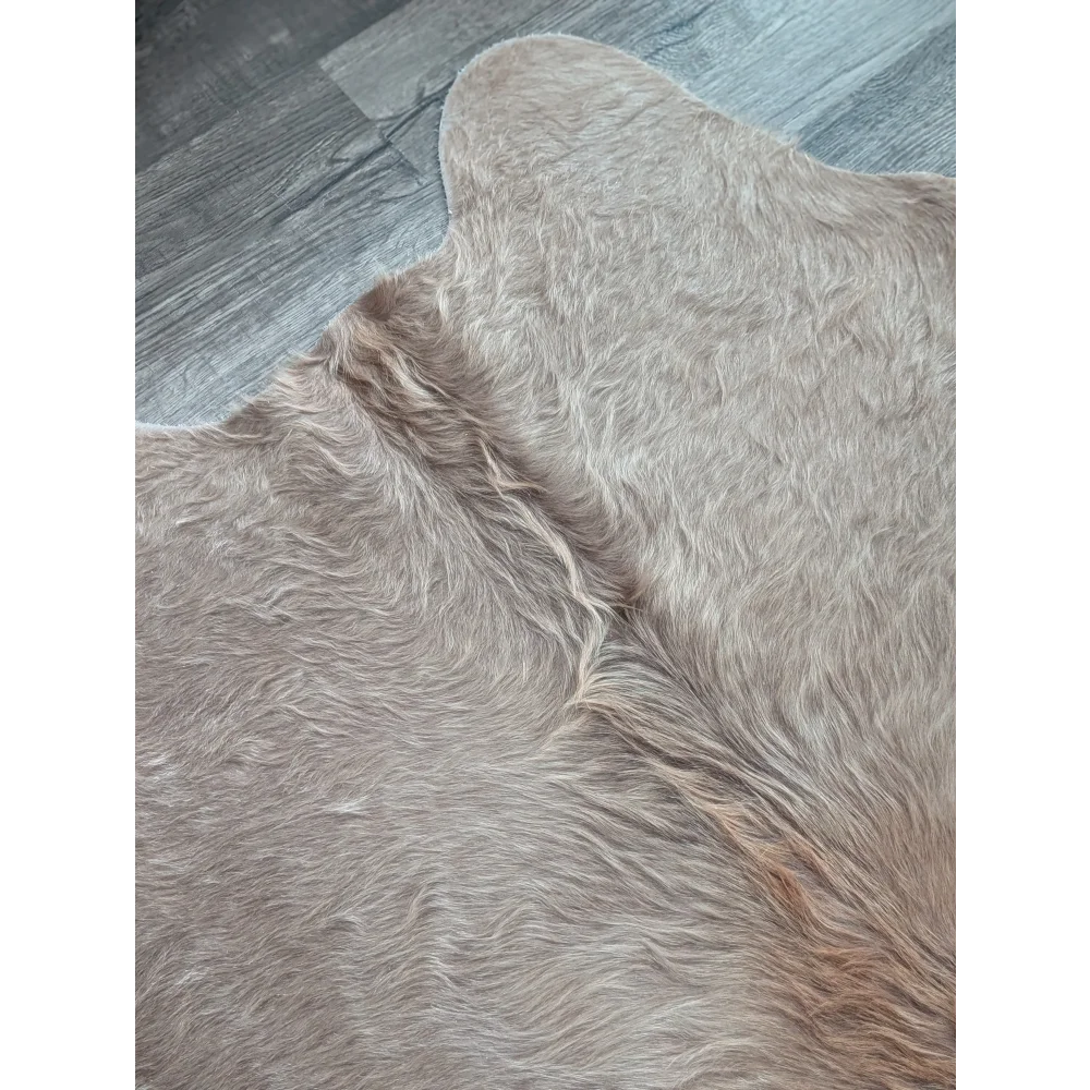 Soft light beige large cowhide rug with natural fluffy texture and unique characteristics perfect for beautiful rugs