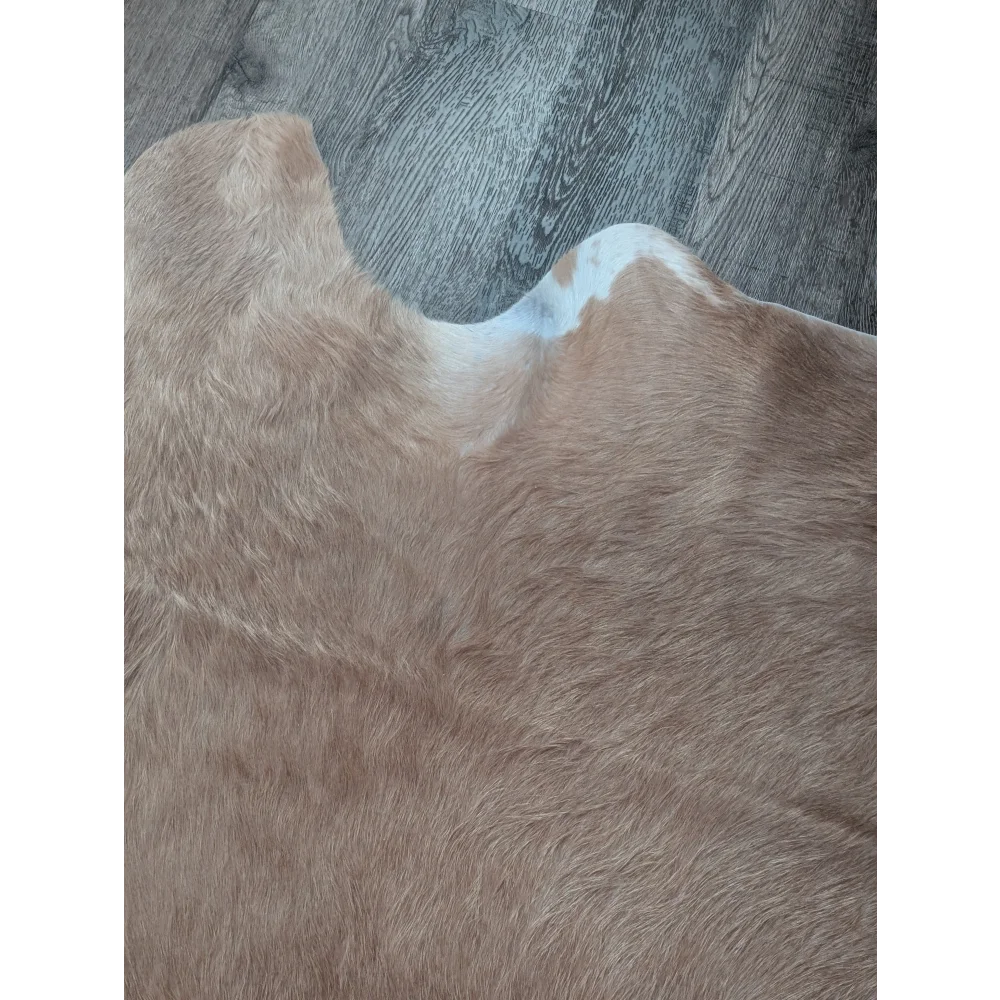 Tan and white faux fur large cowhide rug with natural textured surface showcasing beautiful rugs unique characteristics