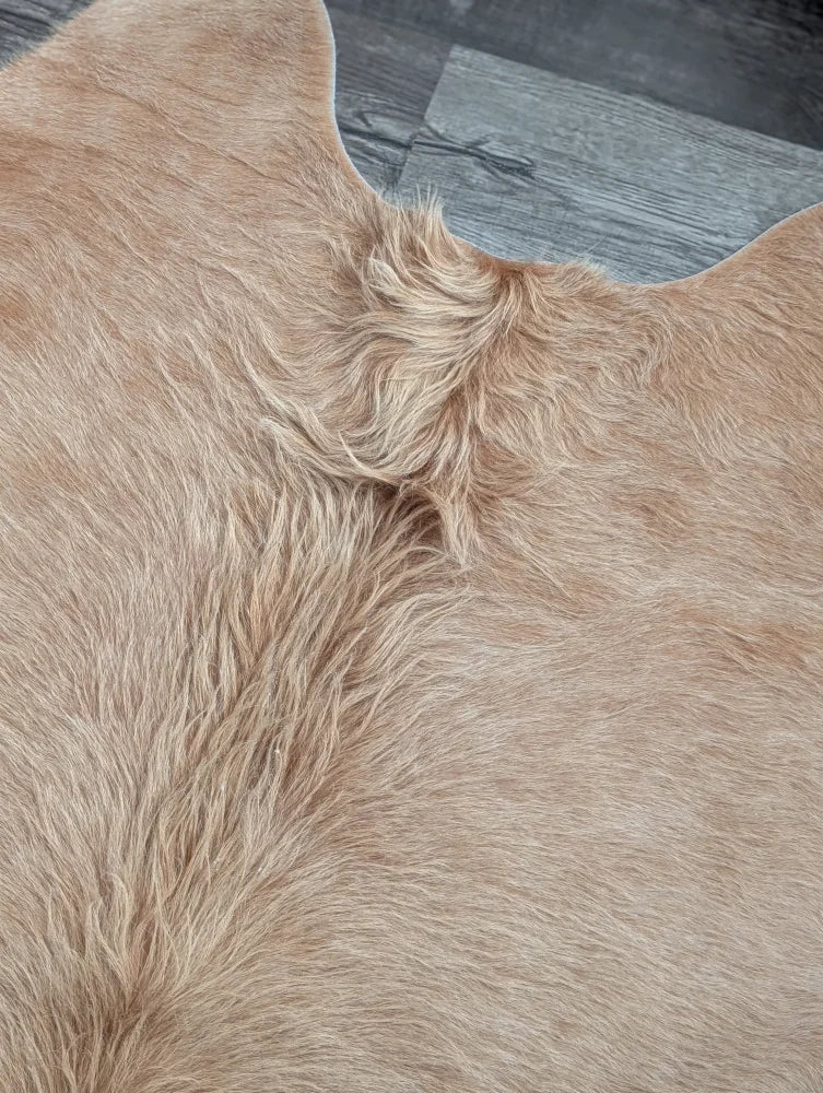 Tan faux fur cowhide rug with soft plush texture and natural hairline detail perfect for beautiful rugs and large cowhide buyers