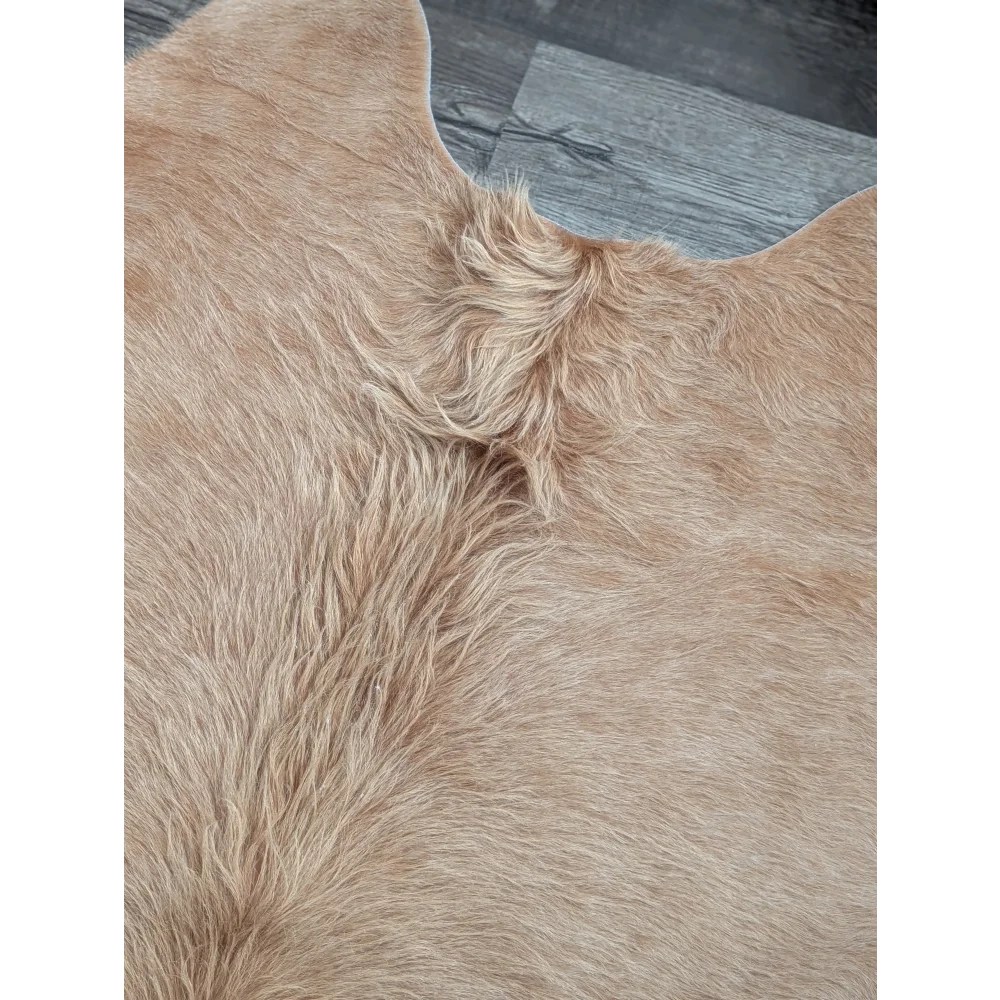 Tan faux fur cowhide rug with soft plush texture and natural hairline detail perfect for beautiful rugs and large cowhide buyers