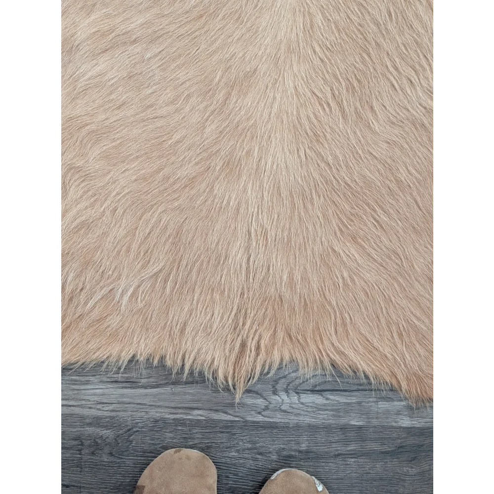 Beige faux fur large cowhide rug with long dense fibers showcasing beautiful rugs and unique characteristics on wood floor