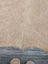 Beige faux fur large cowhide rug with long dense fibers showcasing beautiful rugs and unique characteristics on wood floor