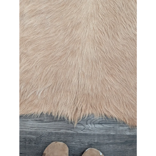 Beige faux fur large cowhide rug with long dense fibers showcasing beautiful rugs and unique characteristics on wood floor