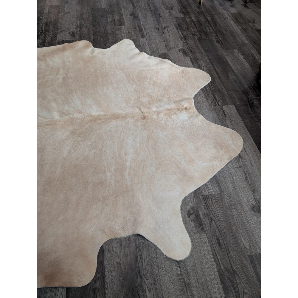 Beige large cowhide rug with natural fur texture and unique irregular edges from beautiful rugs collection cow3