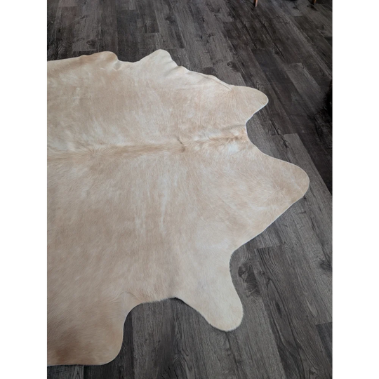 Beige large cowhide rug with natural fur texture and unique irregular edges from beautiful rugs collection cow3