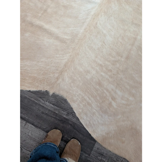 Beige faux fur large cowhide rug with soft plush texture and unique characteristics for beautiful rugs decor
