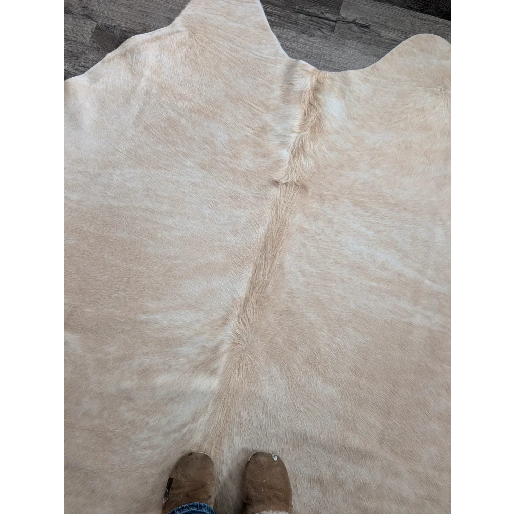 Beige large cowhide rug with natural fluffy texture and subtle tone variations perfect for beautiful rugs collection